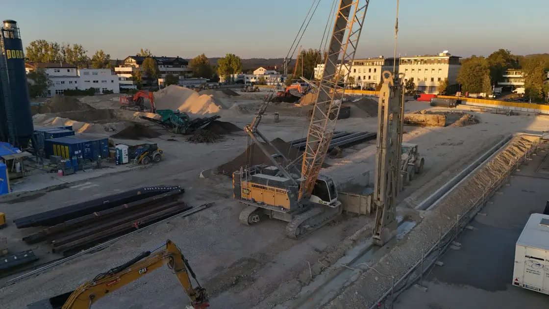 Cable excavator and drilling rig on the moosaik construction site in the evening light