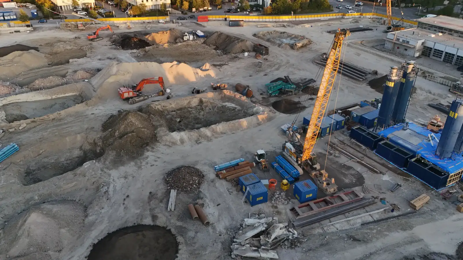Excavators and construction machinery on the moosaik building site, drone shot